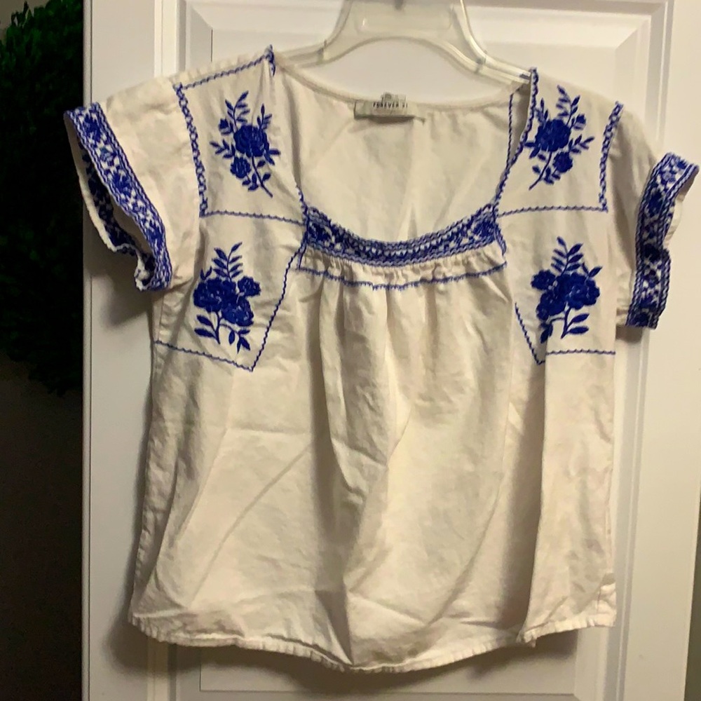 White shirt sleeve top with blue embroidery